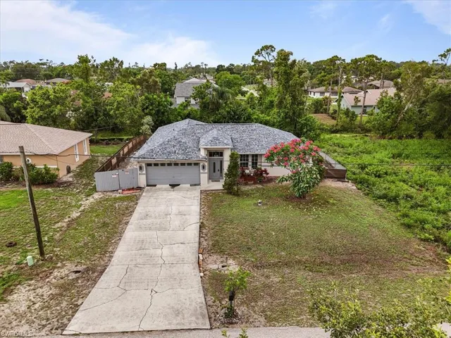 Ranch-style house featuring an attached garage and concrete driveway