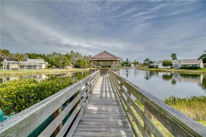 View of fishing dock with a gazebo and a water view