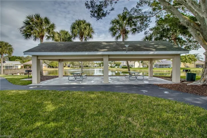 Surrounding community featuring a gazebo, a water view, and a lawn