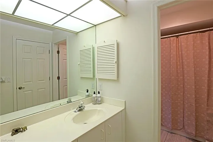 Bathroom featuring vanity and curtained shower tub combo