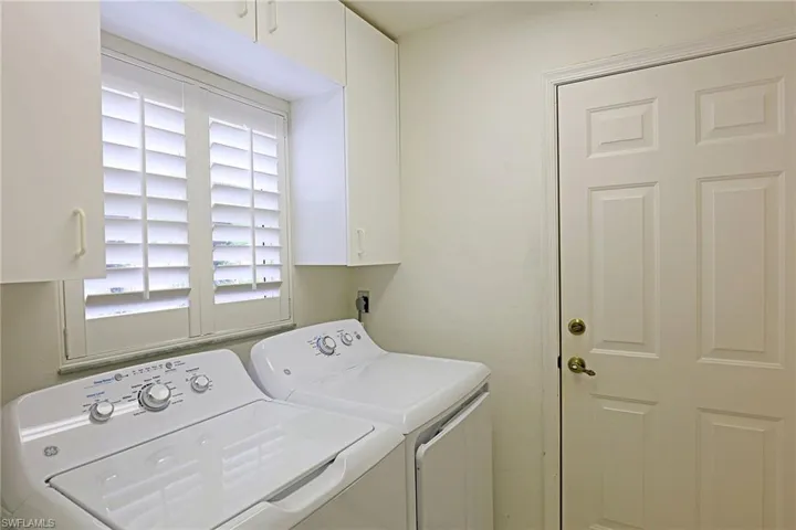 Laundry area featuring washer and dryer and cabinet space