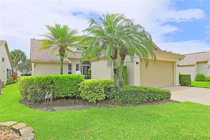 View of front facade with driveway, stucco, a shingled roof, an attached garage, and a front yard
