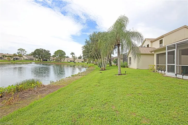 View of green lawn featuring a lake