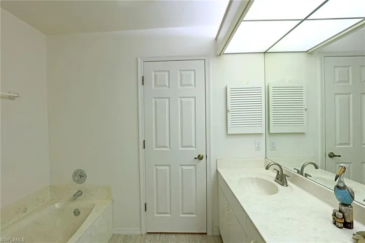 Bathroom with a double vanity and a bath with a separate shower