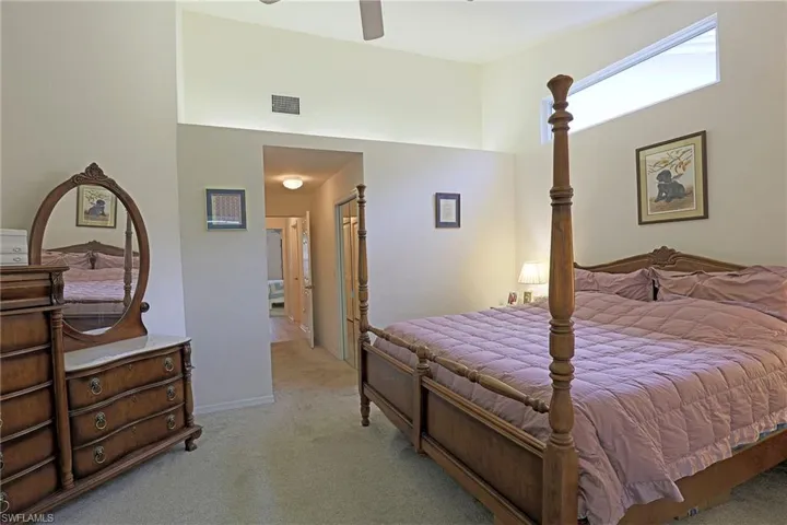 Bedroom featuring light colored carpet and ceiling fan