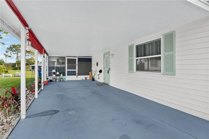 View of patio with a sunroom