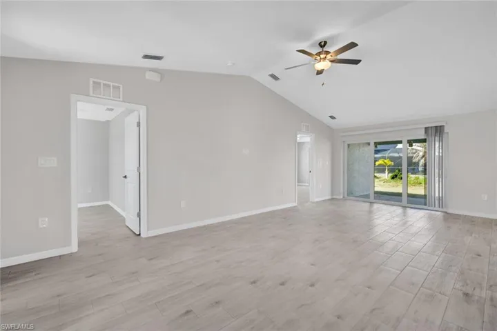 Slider to the Patio from Living Area and Entrance to the Primary and First Spare Bedroom