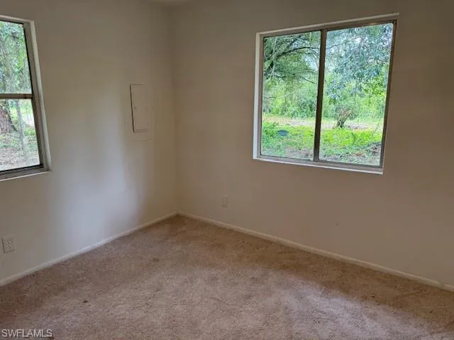 Empty room with carpet and electric panel