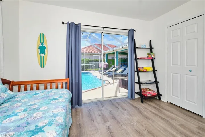 Bedroom featuring access to exterior, light wood-style floors, and a closet