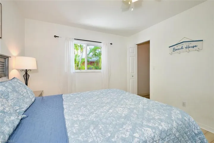 Bedroom featuring a ceiling fan and baseboards