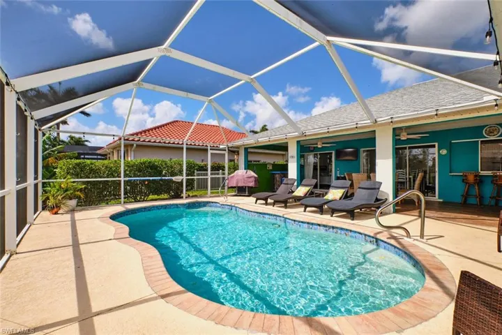 Swimming pool with a patio, a lanai, and a sunroom