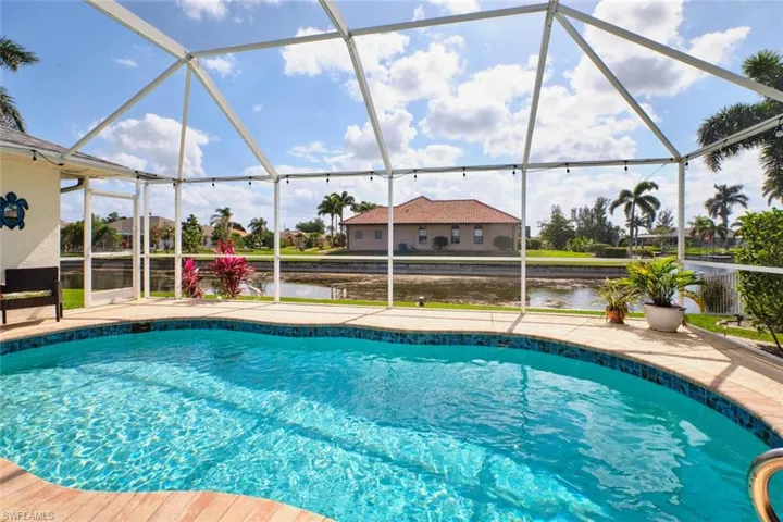 Swimming pool featuring a sunroom, a lanai, and a water view