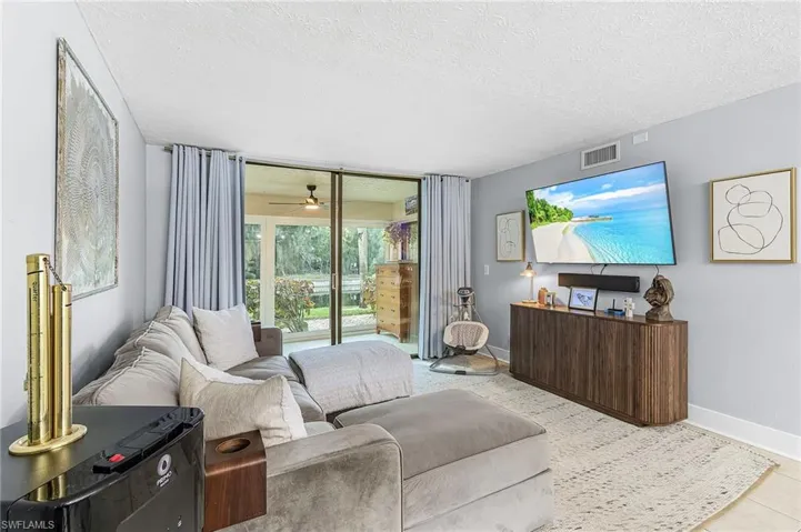 Living area featuring a textured ceiling and ceiling fan