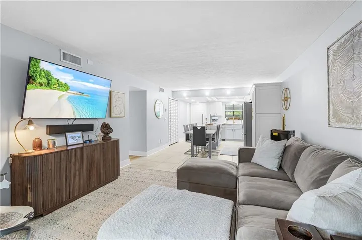 Living area featuring a textured ceiling and light tile patterned floors
