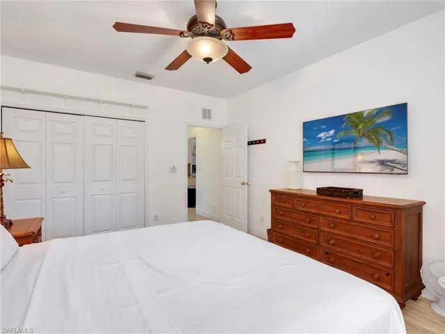 Bedroom with ceiling fan and a closet