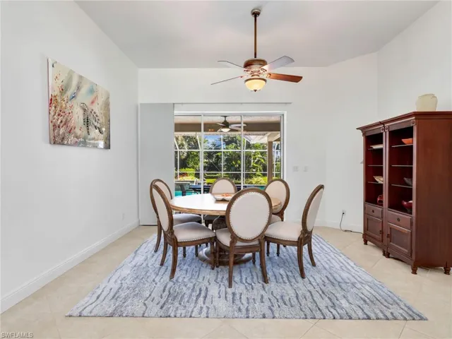 Dining room featuring a ceiling fan, a sunroom, and light tile patterned floors