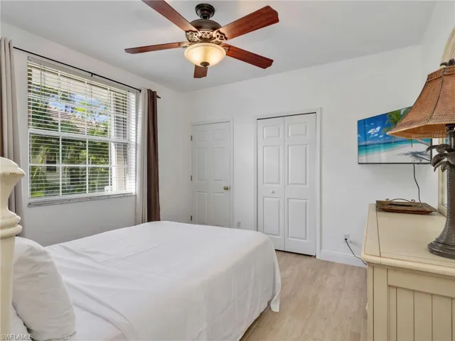 Bedroom featuring a ceiling fan, light wood-type flooring, and a closet