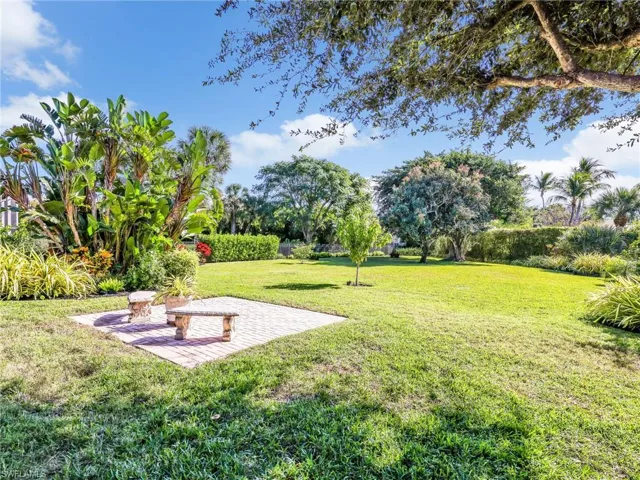 View of grassy yard featuring a patio area