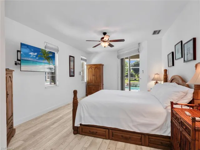 Bedroom featuring a ceiling fan, light wood-type flooring, and access to outside