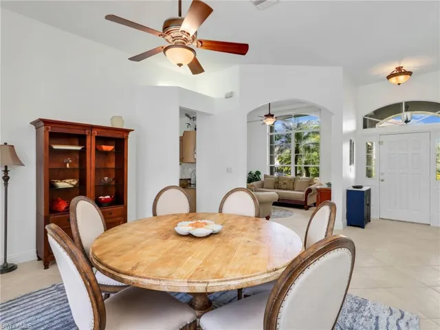 Dining space featuring light tile patterned flooring and a ceiling fan