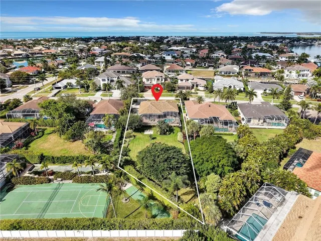 Aerial perspective of suburban area featuring a large body of water