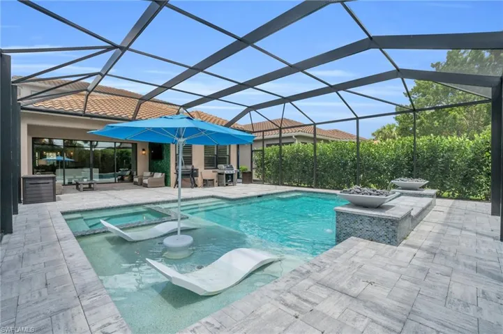View of pool featuring an in ground hot tub, a lanai, a patio area, and area for grilling