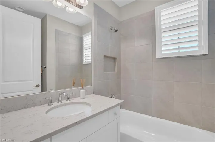 Bathroom featuring tiled shower / bath and oversized vanity