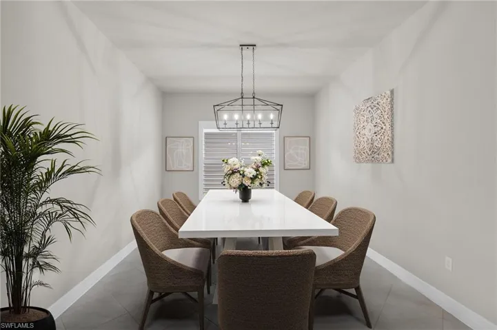 Dining space featuring an inviting chandelier and tile flooring