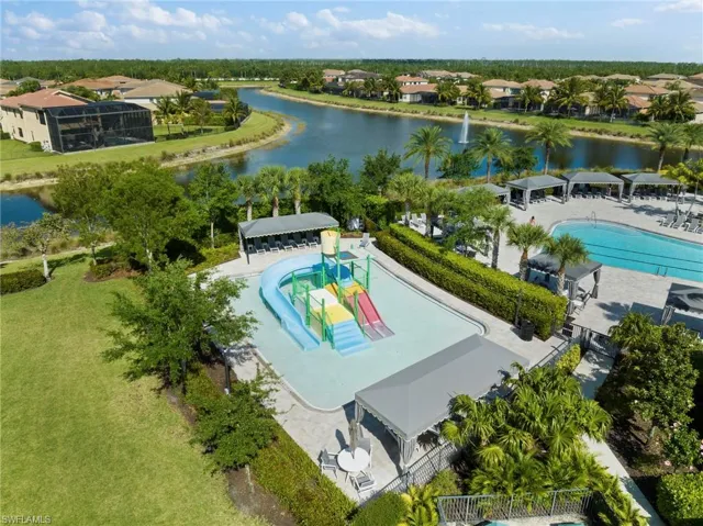 Birds eye view of property with a water view