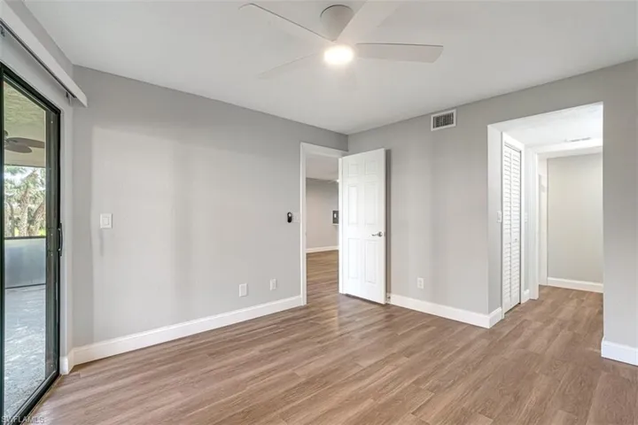 Empty room with a ceiling fan and light wood-type flooring