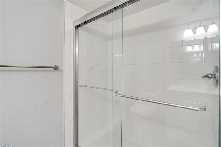 Bathroom with vanity, wood finished floors, and a textured wall