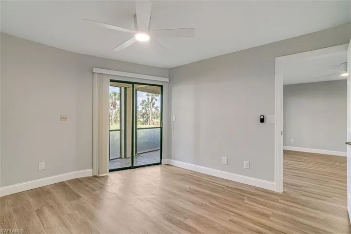 Empty room with a ceiling fan and light wood-style flooring
