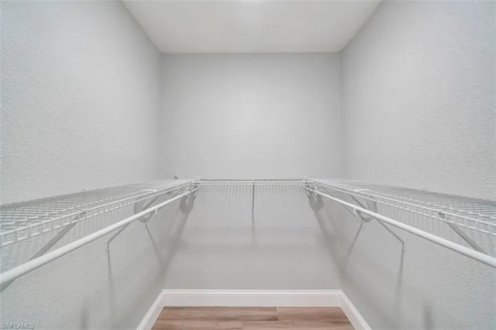 Spacious closet with light wood-type flooring