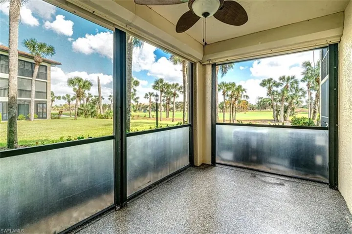 Unfurnished sunroom featuring ceiling fan