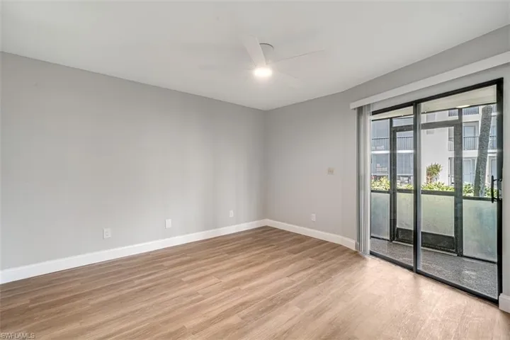 Unfurnished room with a ceiling fan and light wood-type flooring