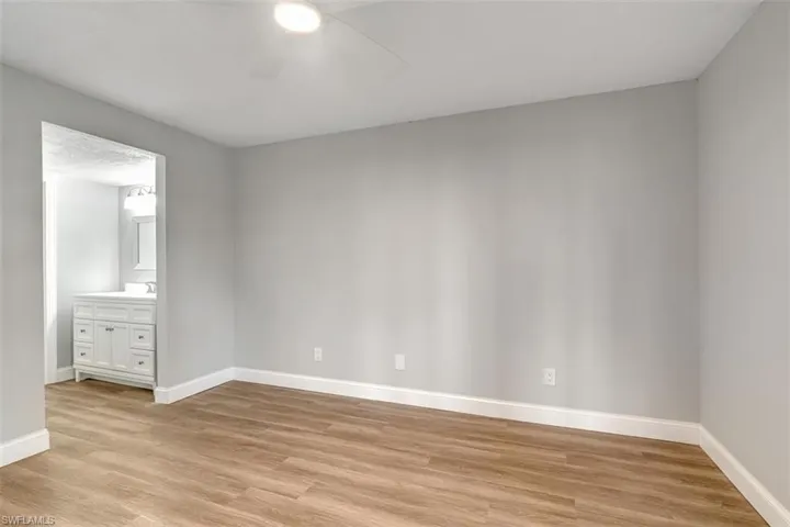 Empty room featuring ceiling fan and light wood-type flooring