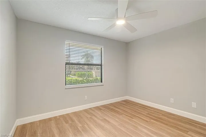 Unfurnished room with light wood-type flooring and a ceiling fan