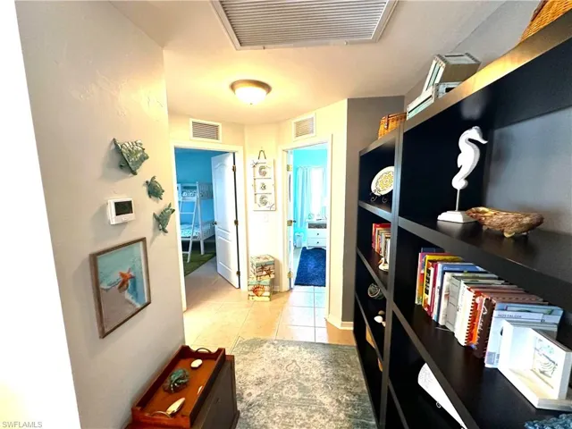 Spacious hallway connecting living room to guest bedrooms and bath