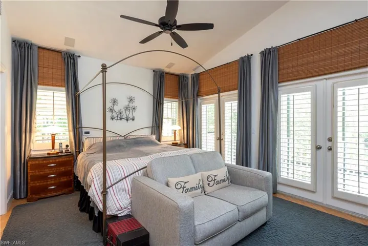 Master Bedroom with Bamboo floor and French Doors leading to balcony, screened Lanai and Pool area