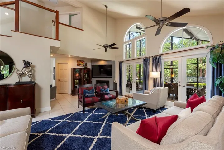 Living area with vaulted ceiling and French Doors leading to the Lanai and pool