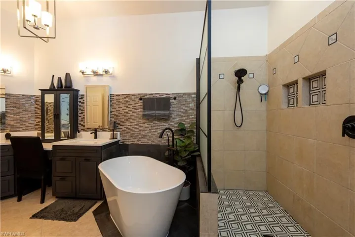 Master bath with a walk in shower and soaking tub