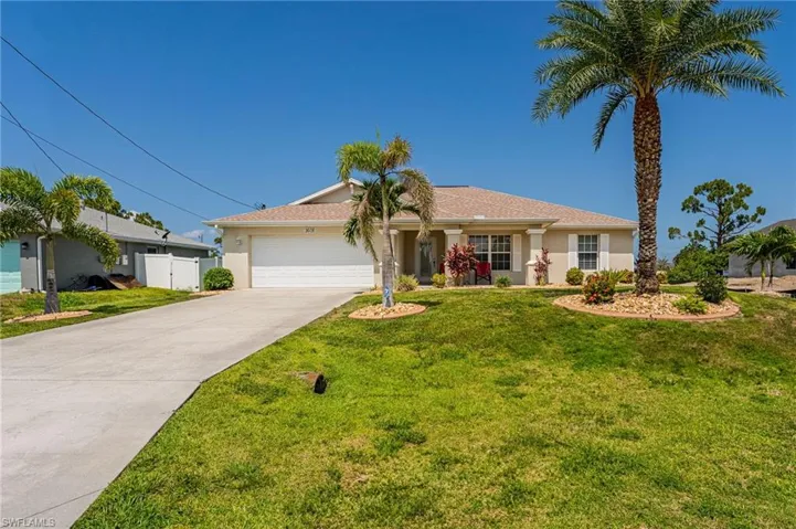 Single story home featuring an attached garage, stucco siding, and driveway