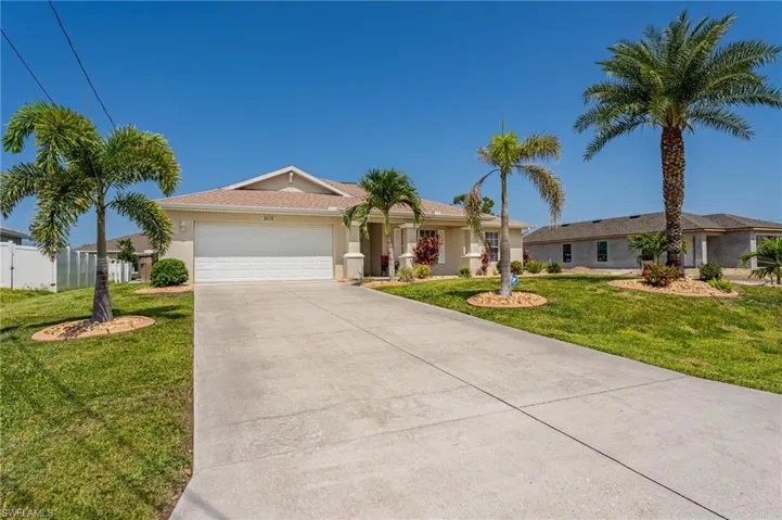 Single story home with a garage, driveway, and stucco siding