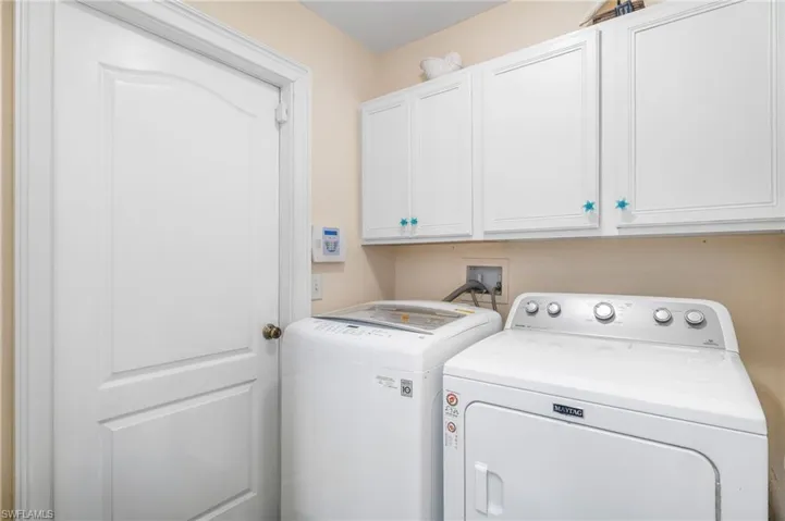 Laundry area featuring washer and dryer and cabinet space