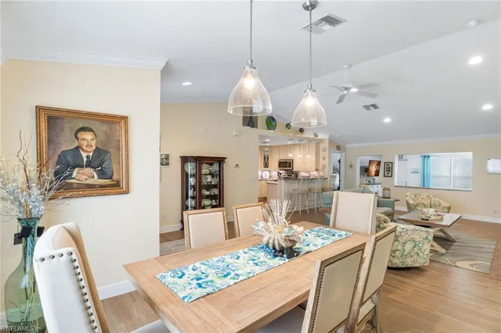 Dining room with crown molding, a ceiling fan, baseboards, light wood-style floors, and recessed lighting