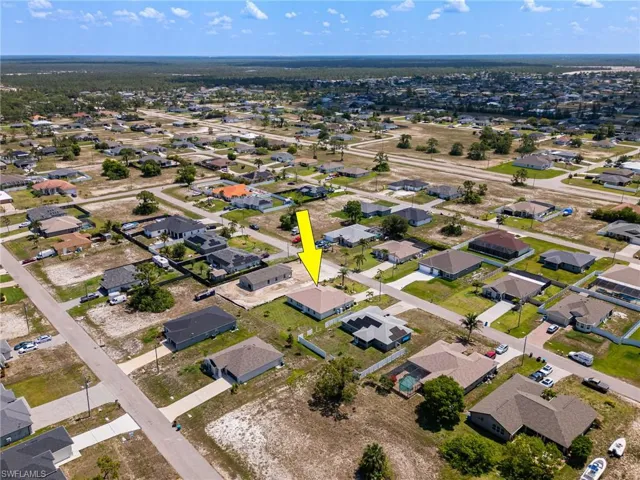 Aerial view of property's location featuring nearby suburban area