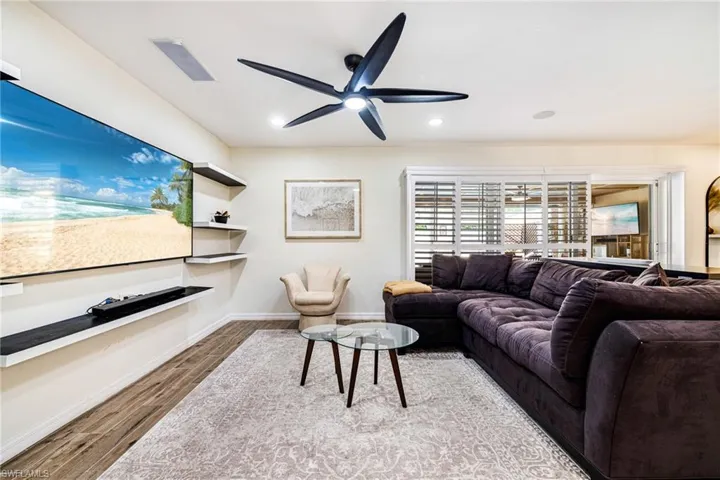 Living area featuring wood finished floors, ceiling fan, and recessed lighting