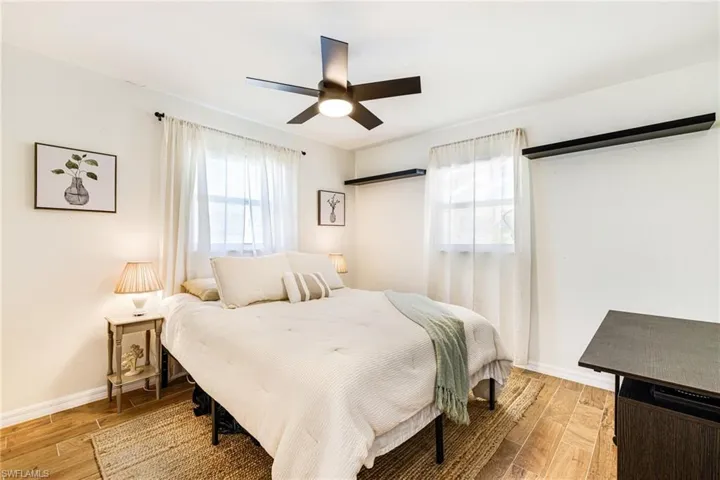 Bedroom with light wood finished floors and ceiling fan
