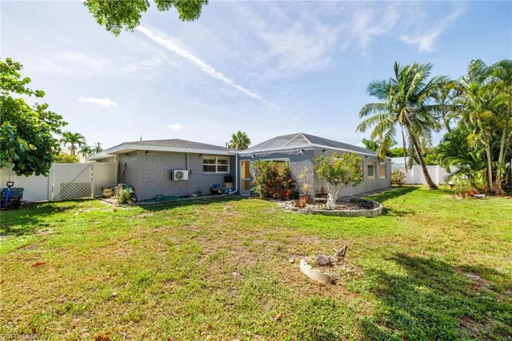 Back of property featuring a fenced backyard, a gate, and stucco siding