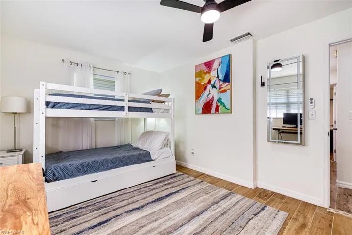 Bedroom featuring wood finished floors and ceiling fan